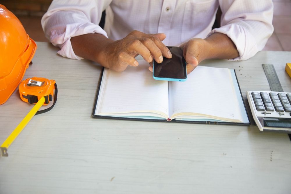 Employee using a mobile app to clock in on a construction site.jpg